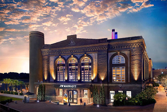 Exterior image of the JW Marriott® Savannah Plant Riverside District Hotel in the evening.